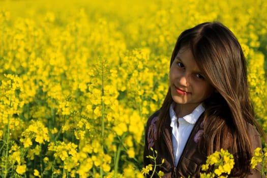 Portrait of a child in a rapeseed field