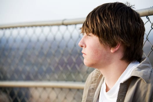 teen portrait against fence