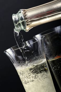 Pour sparkling wine into glasses