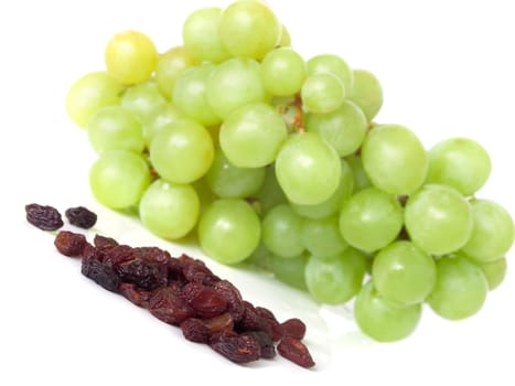 Isolated yellow grape cluster and raisin
