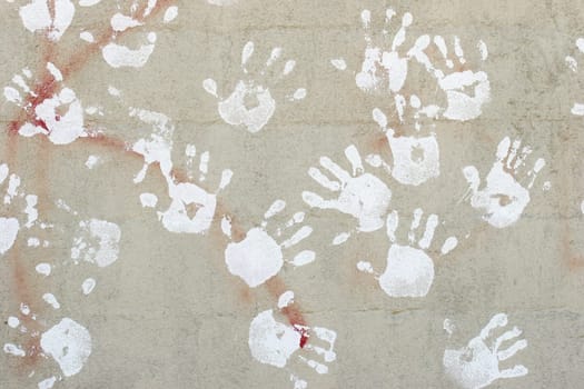 handprints on cement wall
