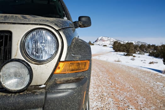 suv closeup on rural snowy road