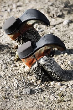 cowboy boots buried in dirt