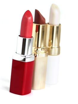 three lipstick on white background