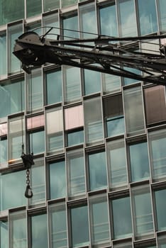 Crane in front of glass façade