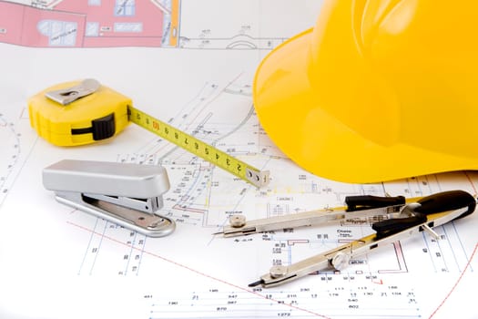 Blueprint with safety helmet and compass