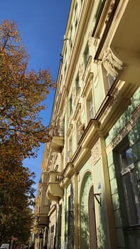 Sunlit autumn building architecture street windows blue sky landscape autumn nature tree vintage . High quality photo