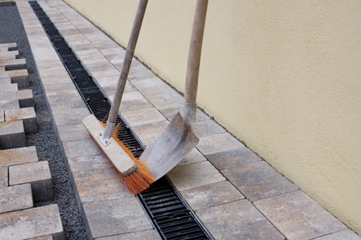 Shovel and broom on new pavement