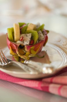 halved pitahaya with fruit salad