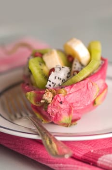 halved pitahaya with fruit salad
