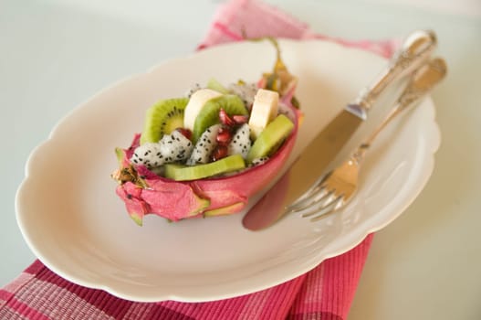 halved pitahaya with fruit salad