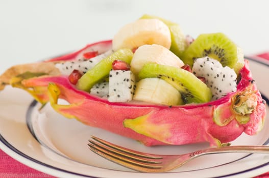 halved pitahaya with fruit salad