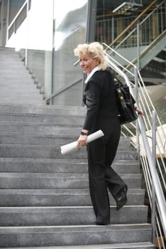 Businesswoman walks up stairs