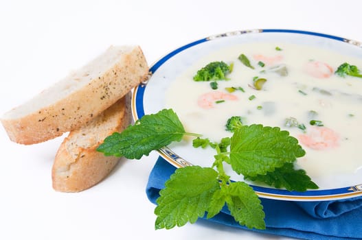 Cream of asparagus soup with broccoli and prawns