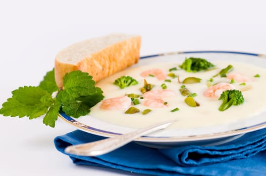 Cream of asparagus soup with broccoli and prawns