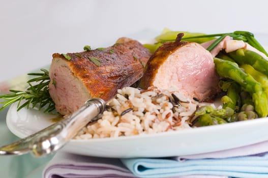 Pork tenderloin with green asparagus on Tel
