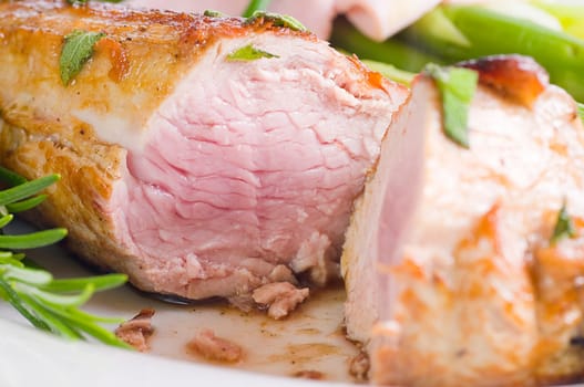 Pork tenderloin with green asparagus on Tel