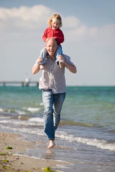 Father with daughter on the beach