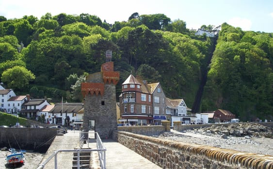 View from the lighthouse pier to the old houses of Lynmouth. To the right of the forest aisle,the Cliff Railway has been running up to the village of Lynton,150m higher,since about 1880.