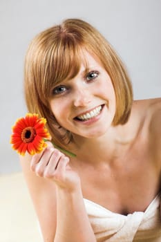 Happy woman at spa with flower