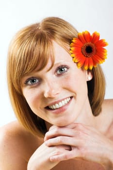 Happy woman at spa with flower