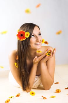 Young woman with falling flowers
