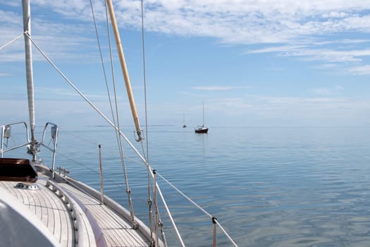 There is a lull in the Baltic Sea,all sailboats are under engine