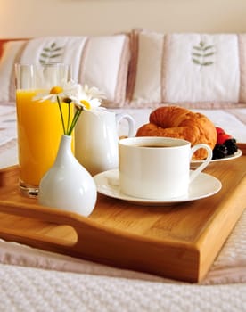 Breakfast on a bed in a hotel room