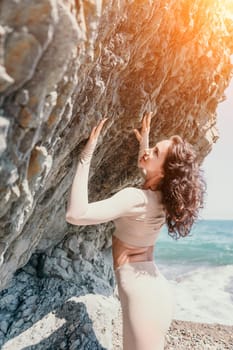 Happy young attractive brunette woman in red swimsuit, on the beach and sea background. Holiday vacation and travel concept.