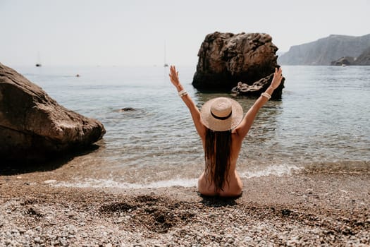 Woman travel sea. Happy tourist taking picture outdoors for memories. Woman traveler looks at the edge of the cliff on the sea bay of mountains, sharing travel adventure journey.