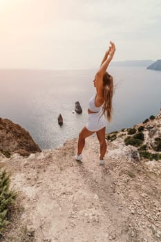 Woman travel sea. Happy tourist in hat enjoy taking picture outdoors for memories. Woman traveler posing on the beach at sea surrounded by volcanic mountains, sharing travel adventure journey