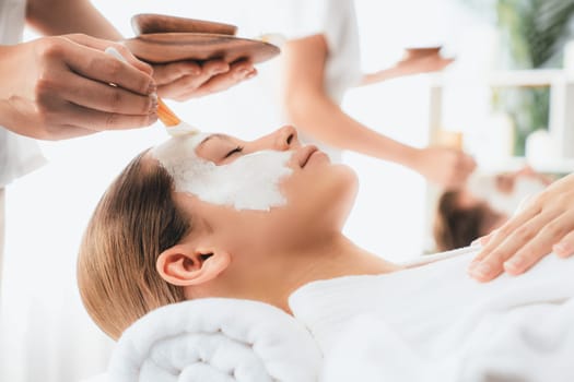 Serene ambiance of spa salon, couple indulges in rejuvenating with luxurious face cream massage with modern daylight. Facial skin treatment and beauty care concept. Quiescent