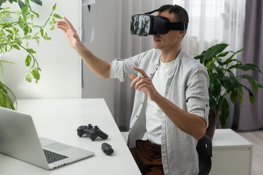 Young bearded man wearing virtual reality glasses in modern interior design coworking studio. Smartphone using with VR goggles headset. Horizontal,flares effect,