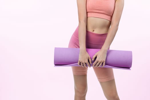 Young attractive asian woman portrait in sportswear with exercising mat. Healthy exercise and workout routine lifestyle concept. Studio shot isolated background. Vigorous