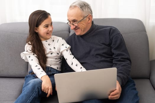 grandfather and granddaughter with laptop.