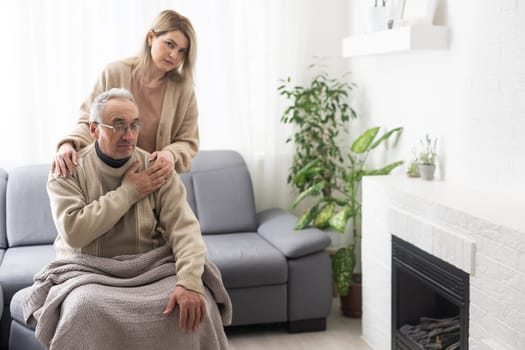 Hands of an elderly man holding the hand of a younger woman.