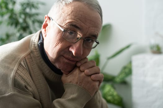 Portrait elderly man on gray background.