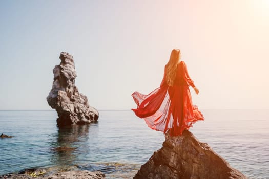 Woman travel sea. Happy tourist taking picture outdoors for memories. Woman traveler looks at the edge of the cliff on the sea bay of mountains, sharing travel adventure journey.