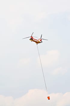 helicopter with water drop bucket