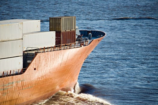container ship heading out to sea