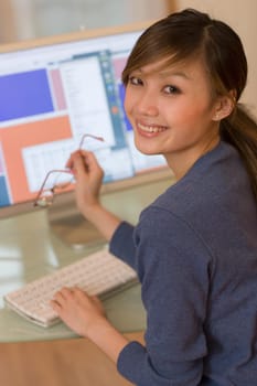 Smiling woman using computer