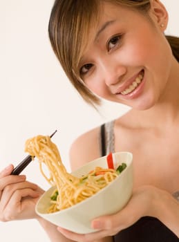 Attractive woman eating noodles
