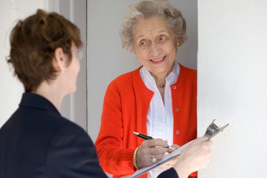 Smiling senior woman signing petetion
