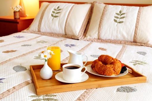Breakfast on a bed in a hotel room