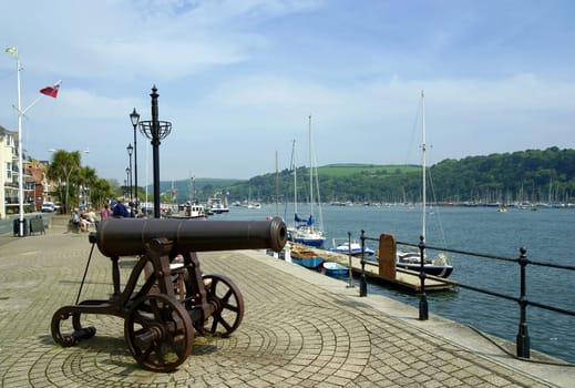Old cannon on the waterfront of Dartmouth in South Devon,UK. The town on the River Dart is a popular destination for travel and excursions,from here you can take many boat tours along the coast in all directions.