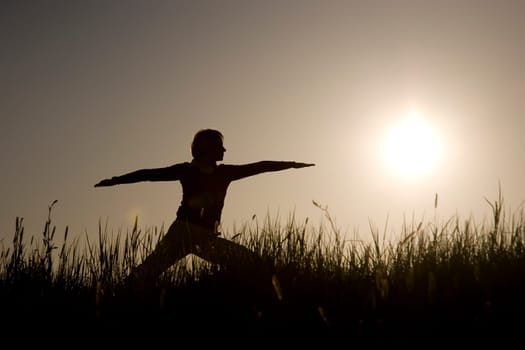Woman doing yoga exercise - The Warrior I