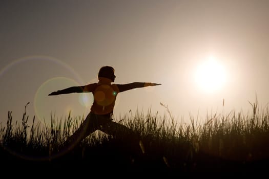Woman doing yoga exercise - The Warrior I