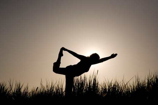 Woman doing yoga exercise - the dancer