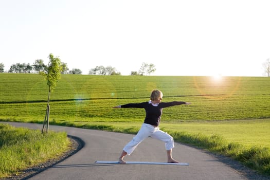 Woman doing yoga exercise - The Warrior I