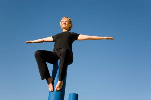 Woman balancing with outstretched arms
